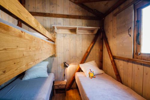 a room with two twin beds in a cabin at Camping Les Pins - Bord de mer in Argelès-sur-Mer