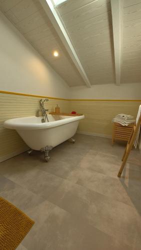 a bathroom with a white tub in a room at ENTRE PIERRE ET BOIS in Saint-Savinien
