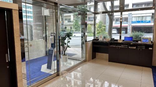 an office with a lobby with a glass wall at Toyoko Inn Oita Nakatsu Ekimae in Nakatsu