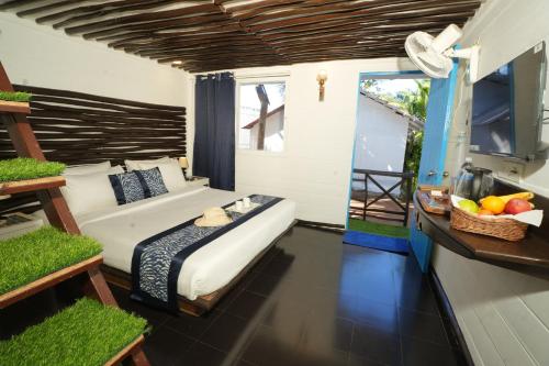 a bedroom with a bed and a table with fruit on it at Beachouse Beachfront Cottages And Suites in Calangute
