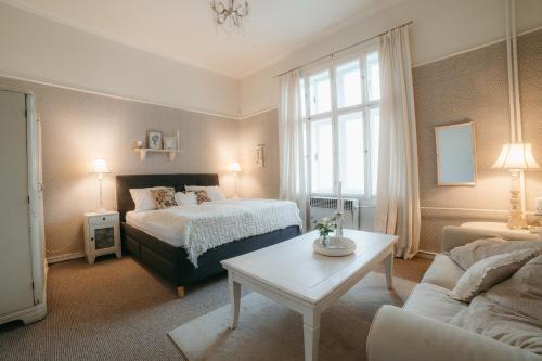 a bedroom with a bed and a table and a couch at Château Josefův Důl in Josefŭv Dŭl