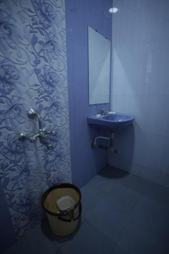 a blue bathroom with a toilet and a sink at Beachouse Beachfront Cottages And Suites in Calangute