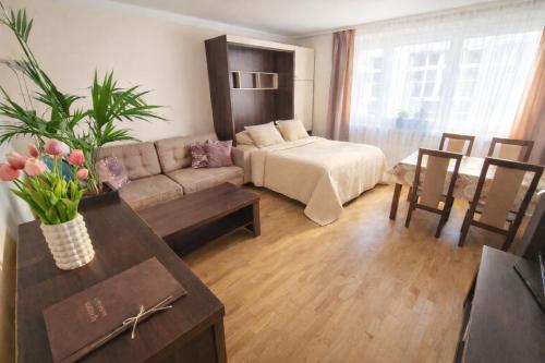 a living room with a couch and a table at Apartment Katamaran in Krakow
