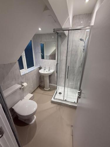 a bathroom with a shower and a toilet and a sink at The Mary Arden Inn in Stratford-upon-Avon