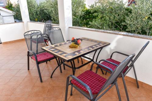 a table and chairs sitting on a balcony at Apartments Purkovic in Vodice