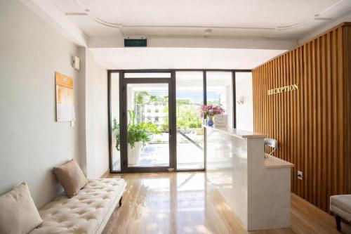 a living room with a couch and a table at Candy Hotel Hạ Long in Ha Long