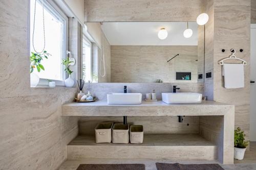 a bathroom with two sinks and a mirror at Villa Empress in Dramalj