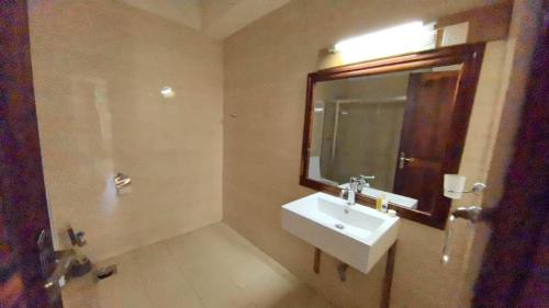 a bathroom with a sink and a mirror at Isamilo Grand Hotel in Mwanza