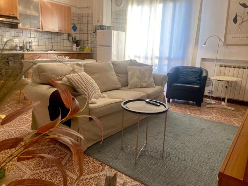 a living room with a couch and a table at Al B6 CLOSE TO VENICE in Mogliano Veneto