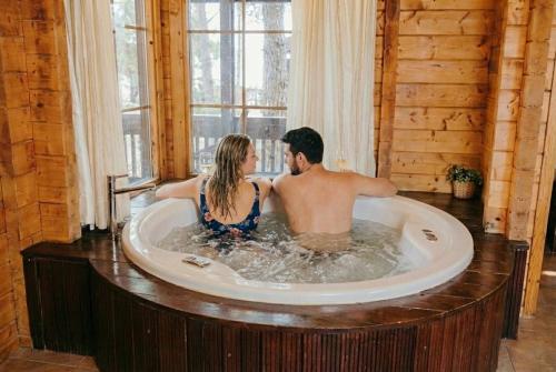a man and a woman sitting in a bath tub at Kibbutz Ortal Tourism in Ortal