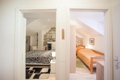 an attic bedroom with two beds and a room with a bed sqor at Villa Tudor in Grohote