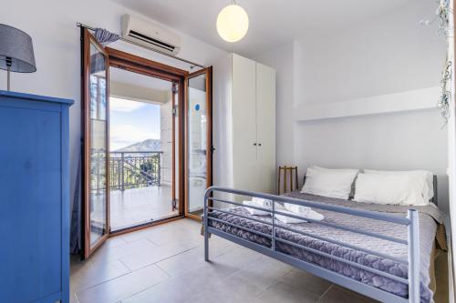 a bedroom with a bed and a balcony at Gallis Villa in Pefkias
