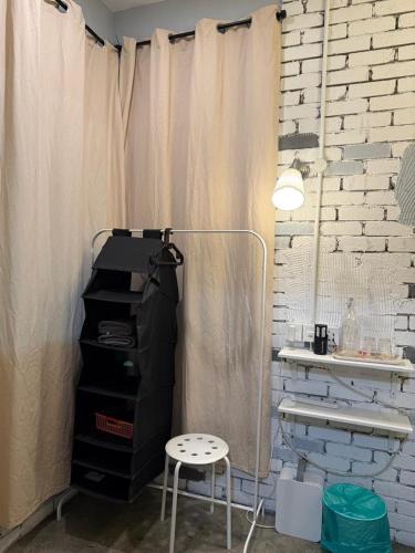 a room with a curtain and a desk and a stool at HuttonSTAY at Georgetown in George Town