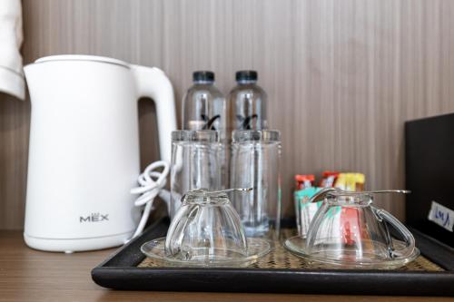 a tray with four glass containers on a table at Tongtong Garden Holiday Hotel普吉岛通通花园酒店 in Rawai Beach