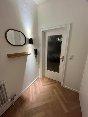 a hallway with a mirror on the wall and a door at Triberg City Apartment 1 in Triberg