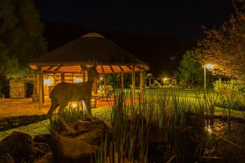 a statue of a deer in front of a gazebo at Lemoenfontein in Beaufort West