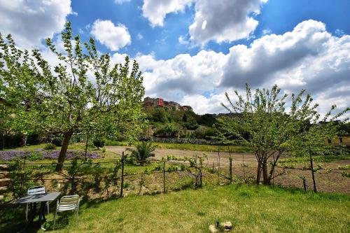 a park with a bench and trees in a field at Giucalem La Casa Negli Orti in Piazza Armerina