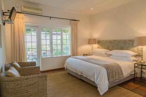 a bedroom with a bed and a large window at Lemoenfontein in Beaufort West