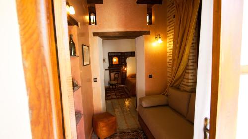 a hallway with a living room with a couch at Ryad Salama in Fès