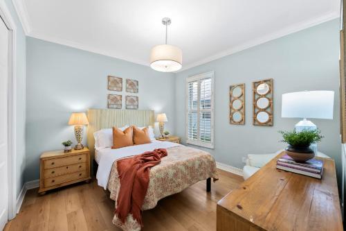 a bedroom with a bed and a wooden table at Neapolitan Vacation Rentals - Pet Friendly, Newly Updated Luxury Home with Private Pool! Complete Privacy and Only a 10 Minute Walk to Vanderbilt Beach Close to Mercato and the Best of Naples in Naples