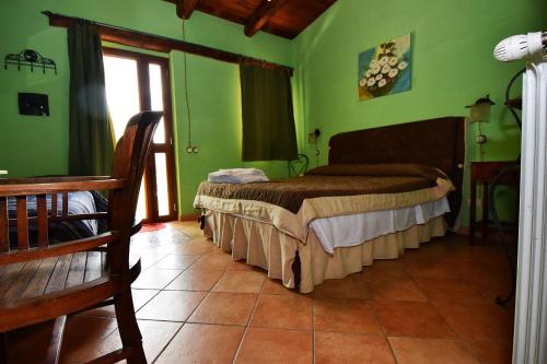 a bedroom with a bed in a room with green walls at Giucalem La Casa Negli Orti in Piazza Armerina