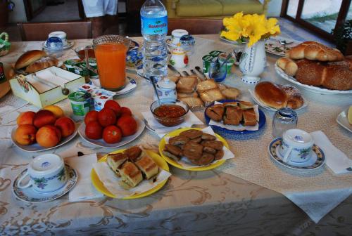 a table with many plates of food on it at Giucalem La Casa Negli Orti in Piazza Armerina