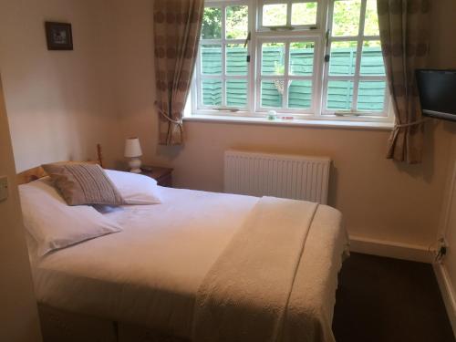 A bed or beds in a room at The Winchfield Inn