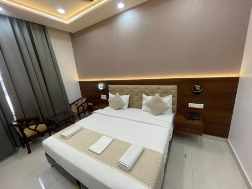 a hotel room with a large bed with two pillows at SR Resort in Milkīpur