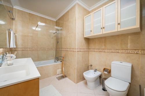 a bathroom with a toilet and a sink at Vila da Praia by ALgest in Alvor