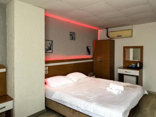 a bedroom with a bed with two towels on it at Avcılar İnci Hotel in Istanbul