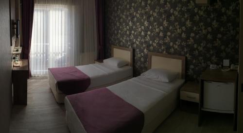 Cama o camas de una habitación en Udi Hotel