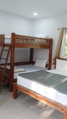 two bunk beds sitting next to each other in a room at Vaplanakhaw Ubon in Ubon Ratchathani