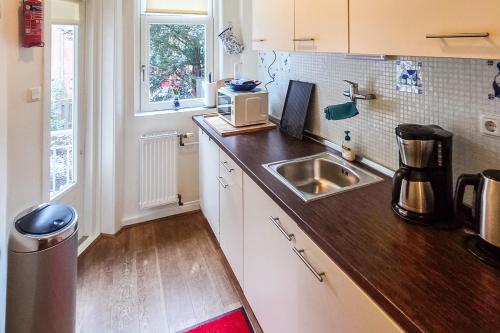 a kitchen with a sink and a counter top at B&B West City Amsterdam in Amsterdam