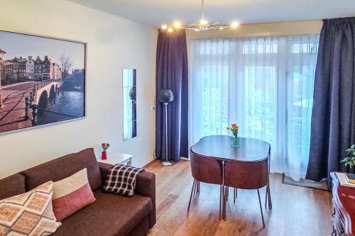 a living room with a couch and a table at B&B West City Amsterdam in Amsterdam