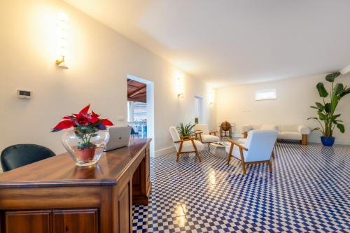 a living room with a table with flowers on it at Villa Bellarosa in Sorrento