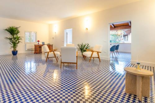 a living room with chairs and a table at Villa Bellarosa in Sorrento