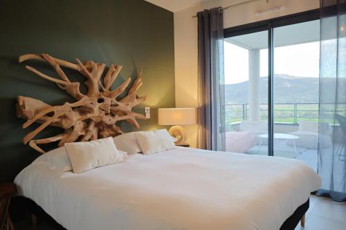 a bedroom with a bed with a large antler headboard at I Salini - T3 élégant & calme près du centre - Classé 4 étoiles in Porto-Vecchio