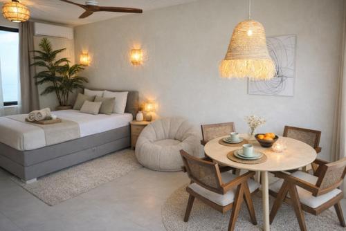 a bedroom with a bed and a table and a chair at SLEEP INN - Kyoto Suites South Antwerp in Antwerp