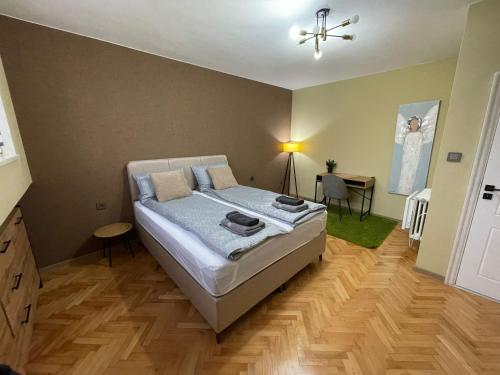 a bedroom with a bed and a desk in it at BM Aparts Rustic in Pleven