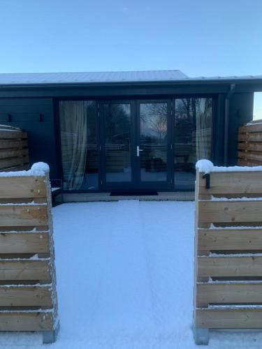 a building with snow on the ground and windows at Farmhouse Bintje met Airco in Westdorpe