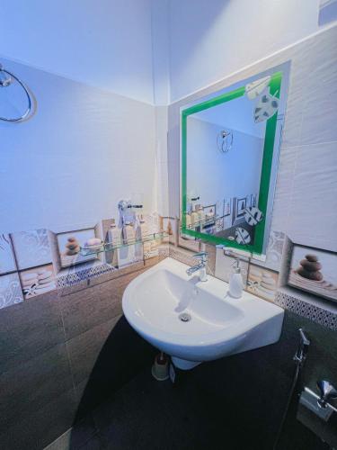 a bathroom with a sink and a large mirror at Nature's Edge Udawalawa in Sinuggala