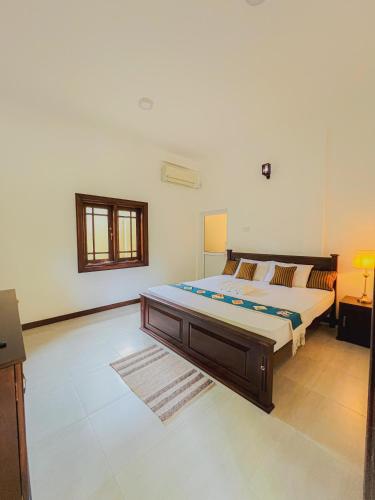 a bedroom with a large bed in a room at Nature's Edge Udawalawa in Sinuggala