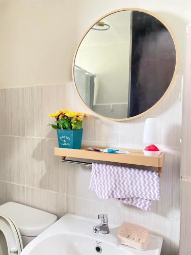 a bathroom with a sink and a mirror at Convenient Condo - Nearby CDO Mall in Pontud