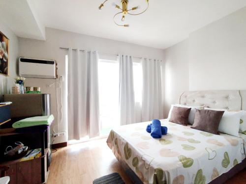 a bedroom with a bed with a teddy bear on it at Convenient Condo - Nearby CDO Mall in Pontud