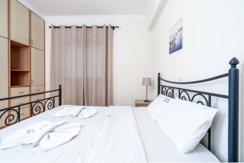 a bedroom with a bed with white sheets and white pillows at Villa Zante Odysseus in Planos