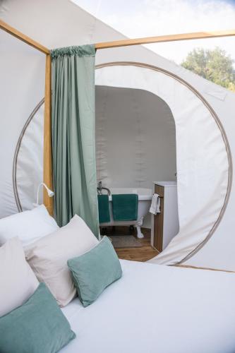 a bedroom with a bed in a tent at Bulle à la Belle étoile in Clécy
