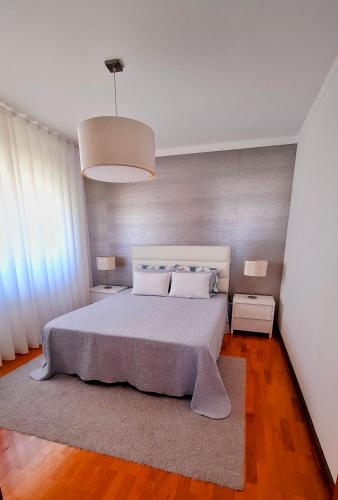 a bedroom with a large bed with two night stands at Casa Lu in Salir de Porto