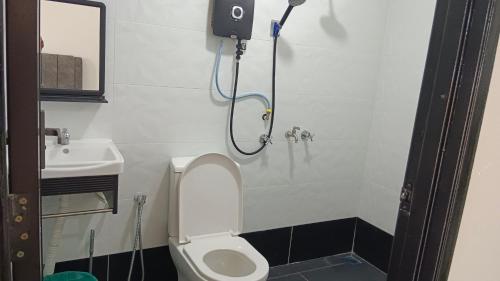 a bathroom with a shower with a toilet and a sink at Makok Seaview roomstay in Kampung Penarik