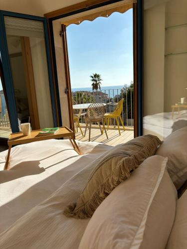 a bedroom with a view of the ocean at Andromeda Sunset Suite & Spa in Tel Aviv