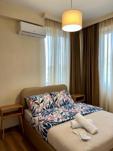 a bedroom with a bed with a towel on it at Central Cozy 2-Bedroom in Tbilisi City